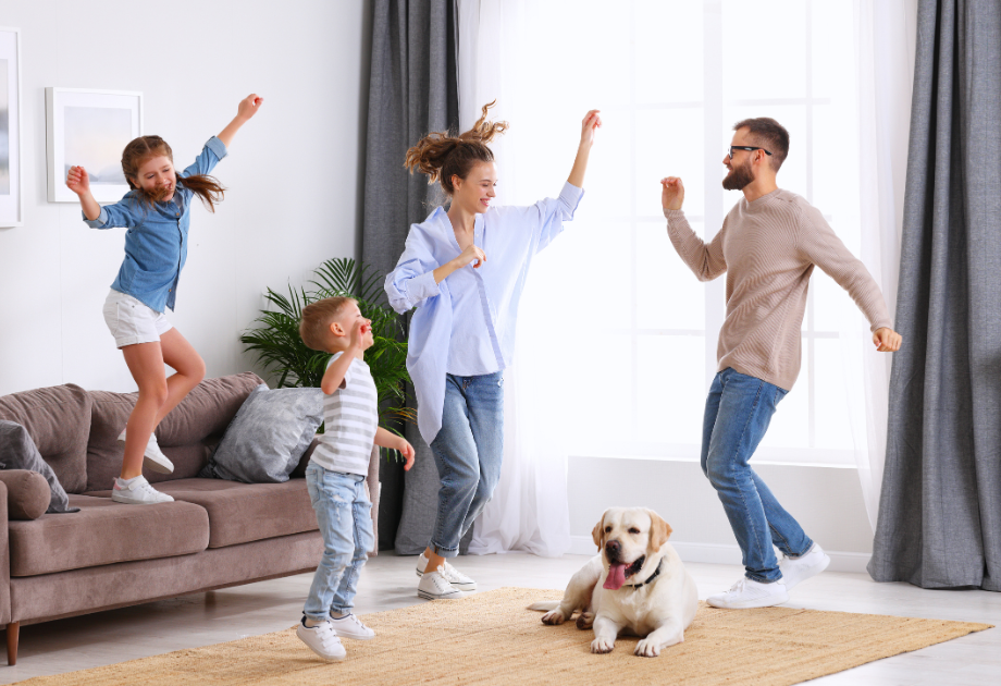 family jumping around in their living room